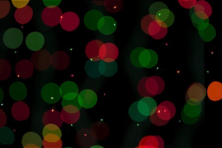 Christmas colorful lights on the black backgroundの写真素材