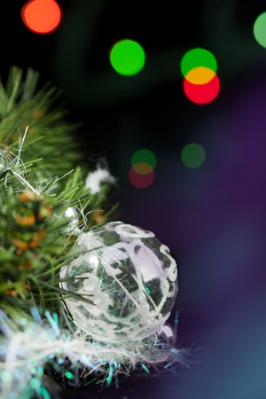Transparent christmas ball with a christmas tree on the black backgroundの写真素材