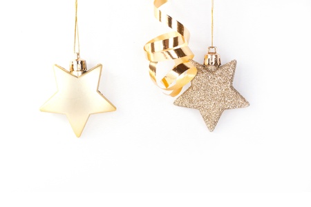 Tow golden christmas stars on the white backgroundの写真素材