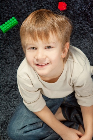 adorable young boy looking at camera の写真素材