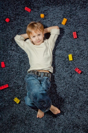 lying young boy looking at camera の写真素材