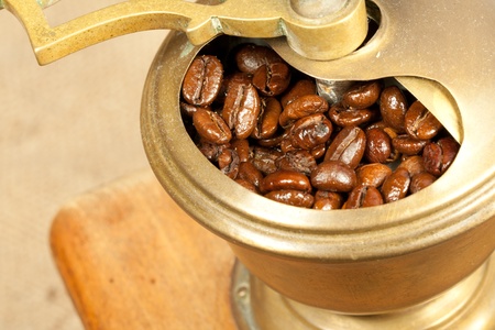 Fragrant fried coffee beans in the wooden old-style coffee grinderの写真素材