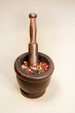 Wooden vintage mortar with pestles and pepperの写真素材