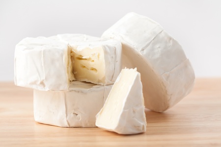 Three pieces of white cheese on the wooden deskの写真素材
