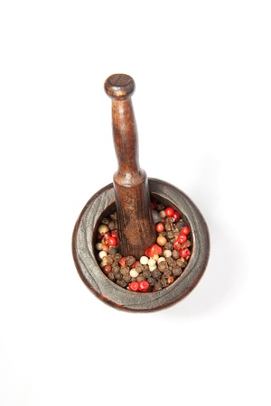 Wooden vintage mortar with pestles and papper isolatedの写真素材