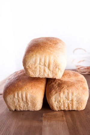 Three loaf of fresh cooking bread on the wooden deskの写真素材