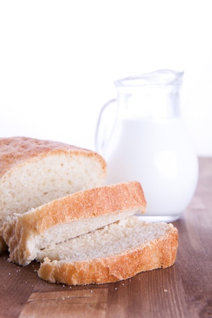 Fresh cooking bread with the jug of a milkの写真素材