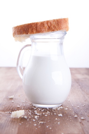 Fresh cooking bread with the jug of a milkの写真素材