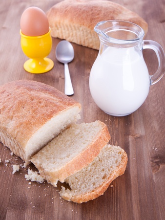 Breakfast with fresh bread, milk and eggの写真素材