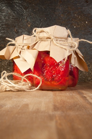 Three pots with snack from red paprika on the wooden tableの写真素材