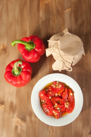 Red paprika in olive oil and fresh red paprikaの写真素材