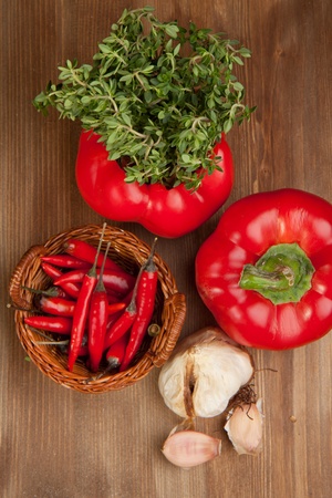 Red paprika, onion and fresh herb on the wooden tableの写真素材