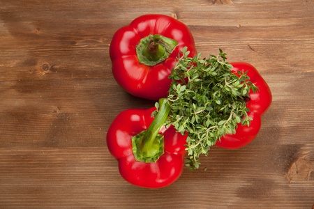 Red paprika with fresh herb on the wooden tableの写真素材