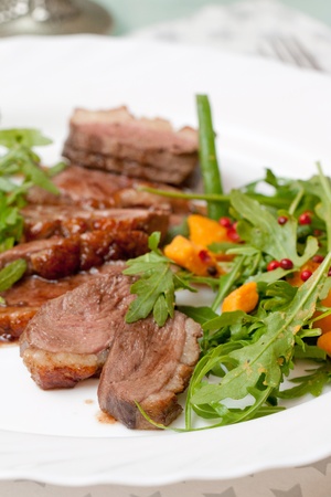 served roasted duck with green saladの写真素材