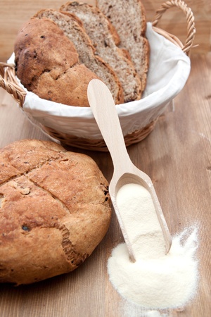 Fresh cooking sliced bread in the basket and whole bread の写真素材