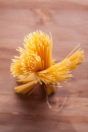 Bunch of spaghetti on a wooden tableの写真素材