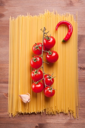 Composition of pasta, garlic, pepper and tomatoの写真素材