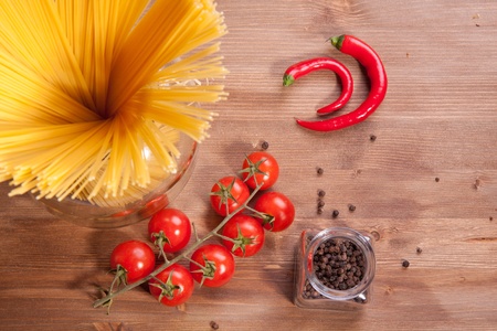 Composition of tow kind of pepper,  italian pasta and tomato cherryの写真素材