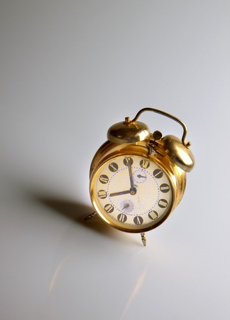 vintage alarm clock with reflection on gray backgroundの写真素材