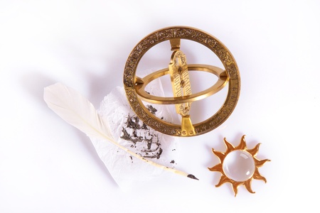 Composition of old measuring instrument for navigation, white feather and golden sunの写真素材