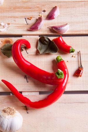 Red hot chili peppers and garlic on the wooden deskの写真素材