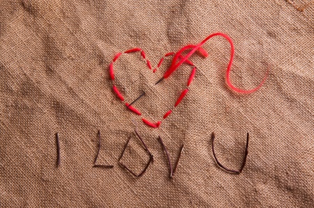 Heart from thread on the sacking. Composition for themes like love, valentine's dayの写真素材