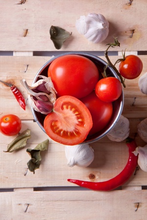 Tomato, garlic and pepper on a wooden deskの写真素材