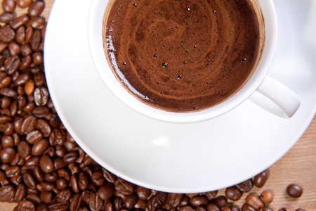 White cup of black coffee with coffee beansの写真素材