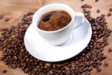 White cup of black coffee with coffee beansの写真素材