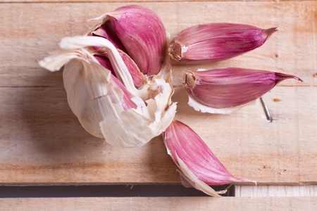 Close-up of garlic on old woodの写真素材