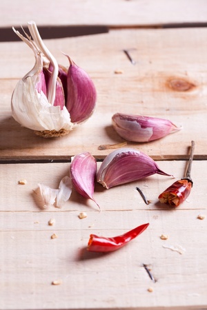 Garlic and dry red pepper on old wooden deskの写真素材