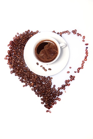 White cup of black coffee with coffee beans as a heartの写真素材