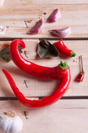 Red hot chili peppers and garlic on wooden deskの写真素材