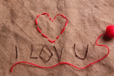 Heart from thread on the sacking. Composition for themes like love, valentine's dayの写真素材