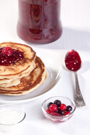 Breakfast with pancakes, fresh berries and strawberry jamの写真素材