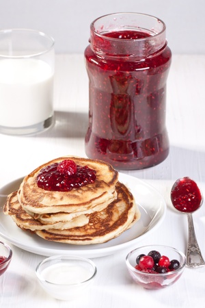 Breakfast with pancakes, fresh berries and strawberry jamの写真素材