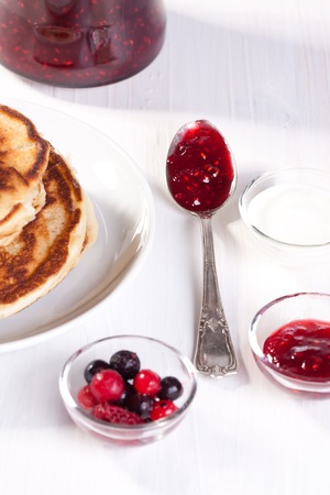 Breakfast with pancakes, fresh berries and strawberry jamの写真素材