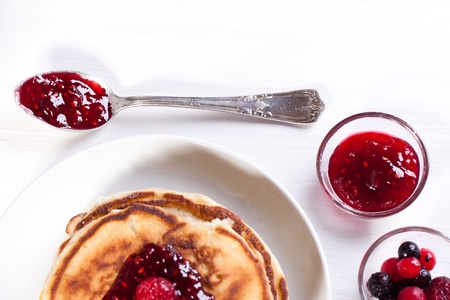 Breakfast with pancakes, fresh berries and strawberry jamの写真素材