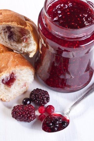 Breakfast with croissant, fresh berries and pot of strawberry jamの写真素材