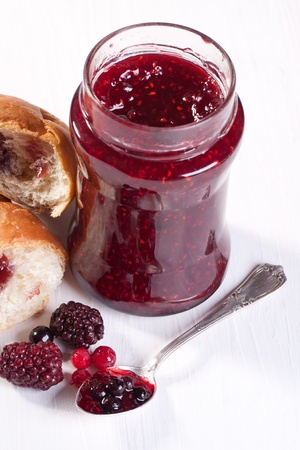 Breakfast with croissant, fresh berries and pot of strawberry jamの写真素材