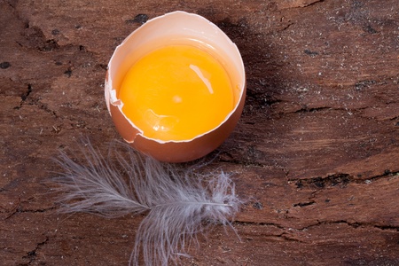Half of Broken egg on wooden backgroundの写真素材