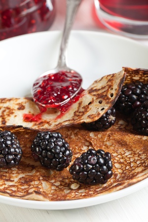 Plate of pancakes with fresh blackberries and strawberry jamの写真素材