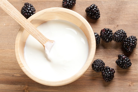 Wooden bowl with Yogurt and blackberriesの写真素材
