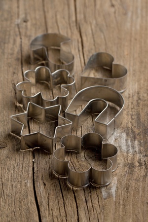 Metal cookie cutters on old wooden table. See seriesの写真素材