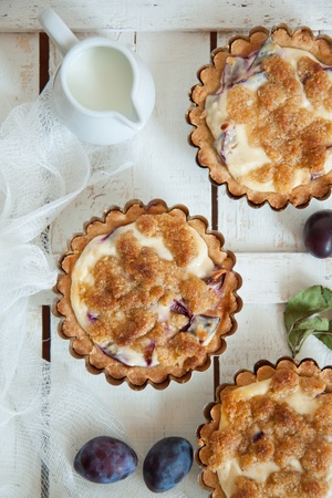 Top view on delicious little tarts with fresh plumsの写真素材