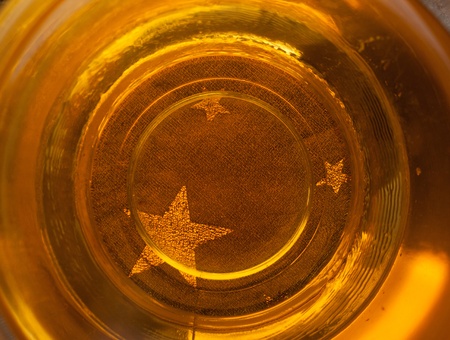 Background with golden stars in cup of teaの写真素材