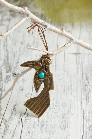 Golden angel figurine on white branch  の写真素材