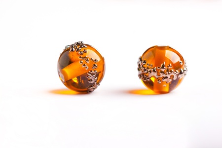 Tow orange glass beads closeup on white background の写真素材