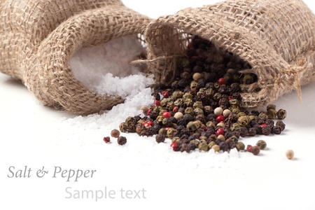 Salt and pepper scattered from sacks over white with sample text