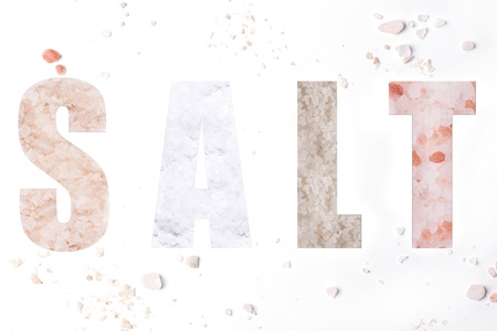 The word salt with mix of four kind of salts over whiteの写真素材